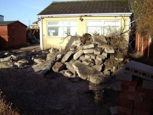 Breaking up old concrete drive surfacing.